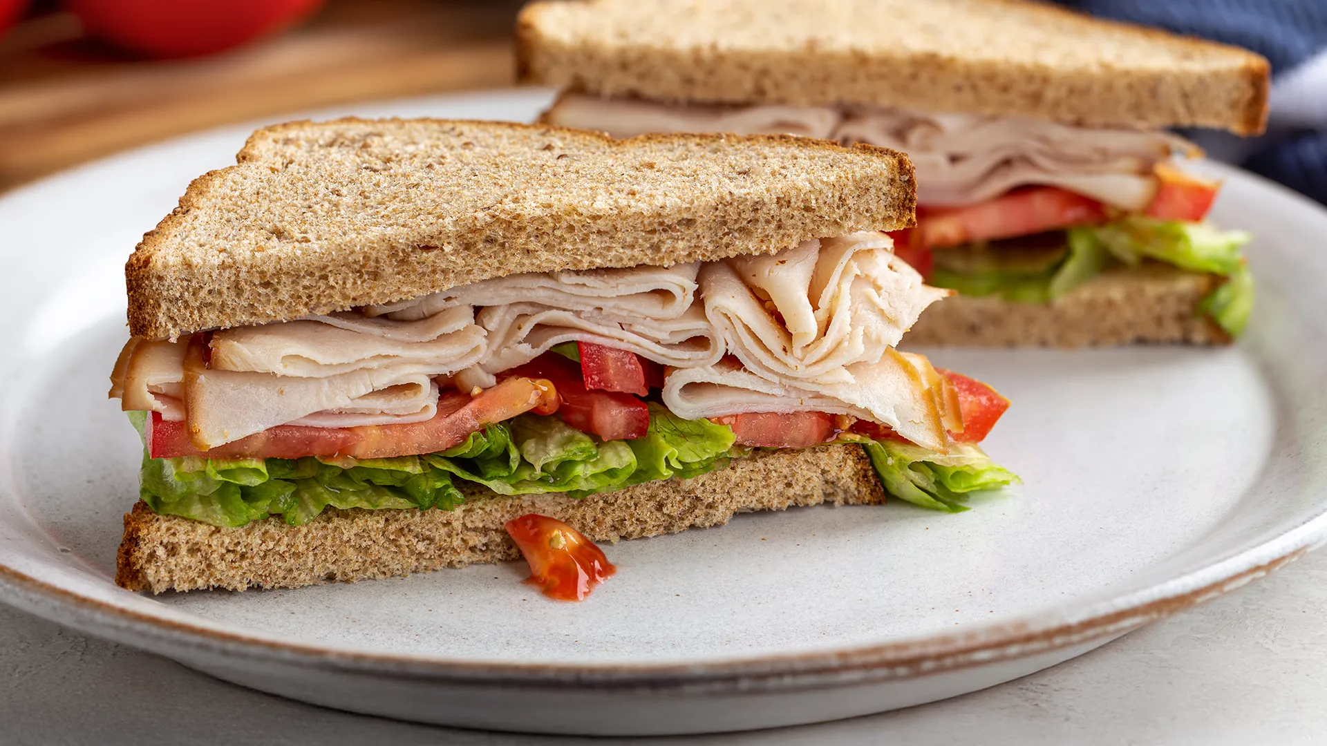 A Nimble® Wholemeal sandwich filled with thin slices of leftover turkey, lettuce, tomato and mayonnaise.