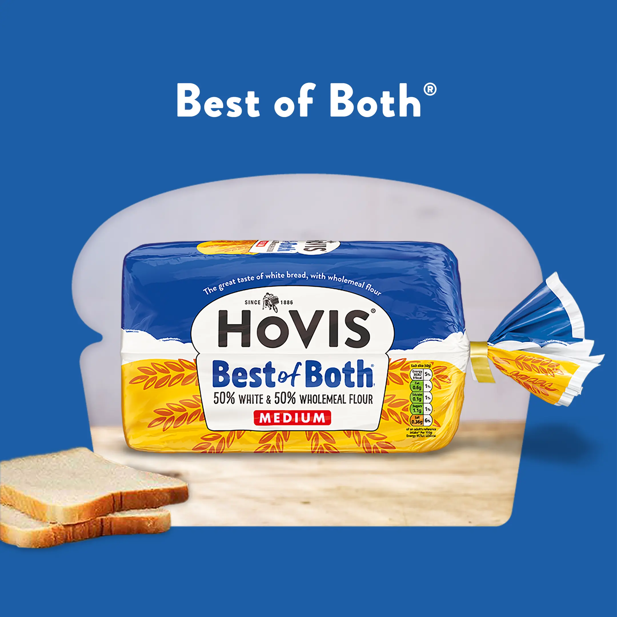 The text reads: Best of Both. A Hovis Best of Both loaf sits on a wooden table with a few slices of bread to the side. Its cropped into a loaf shape with a blue background. 