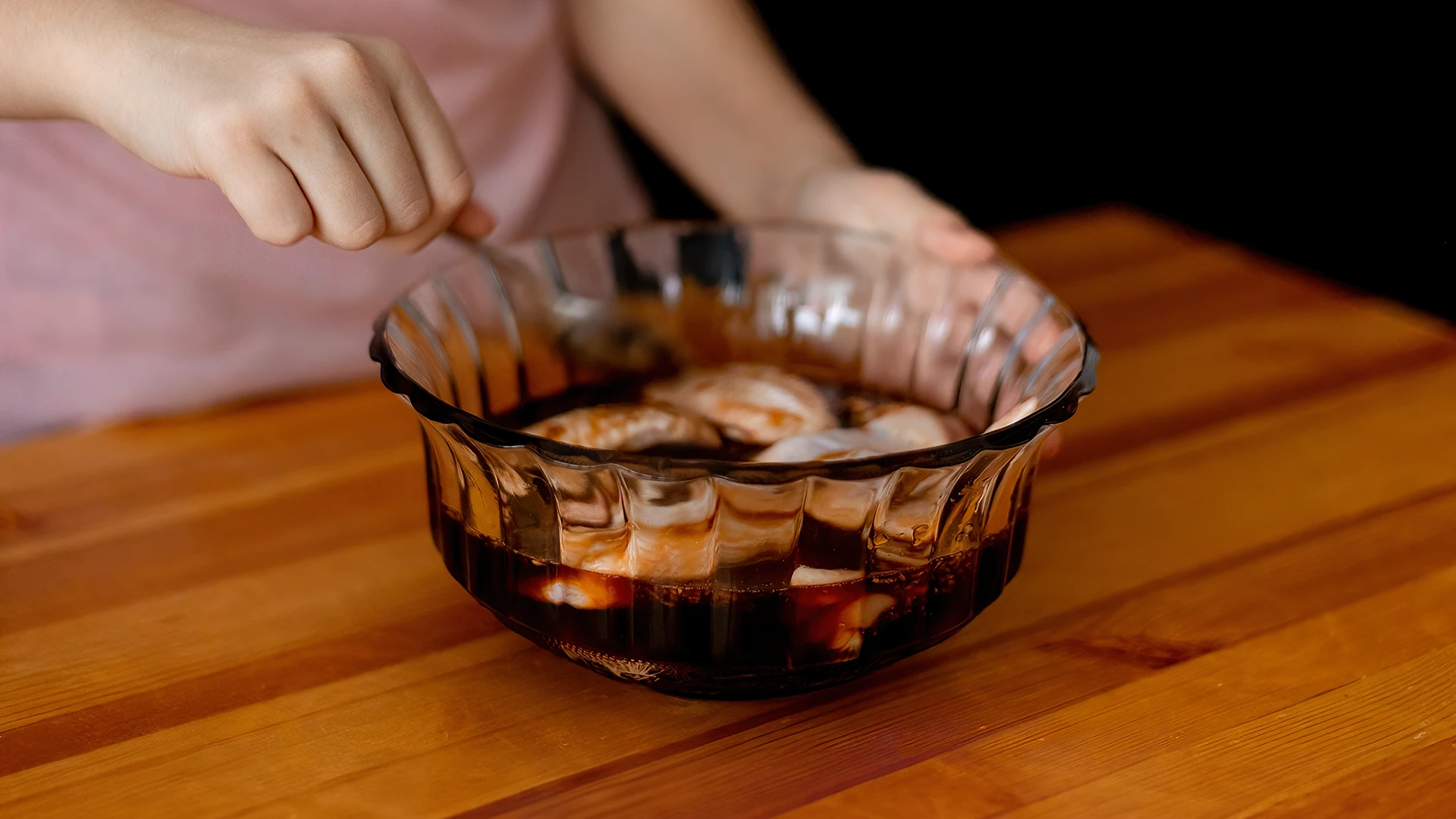 Strips of pork being marinated in mixture of sauces and spices.