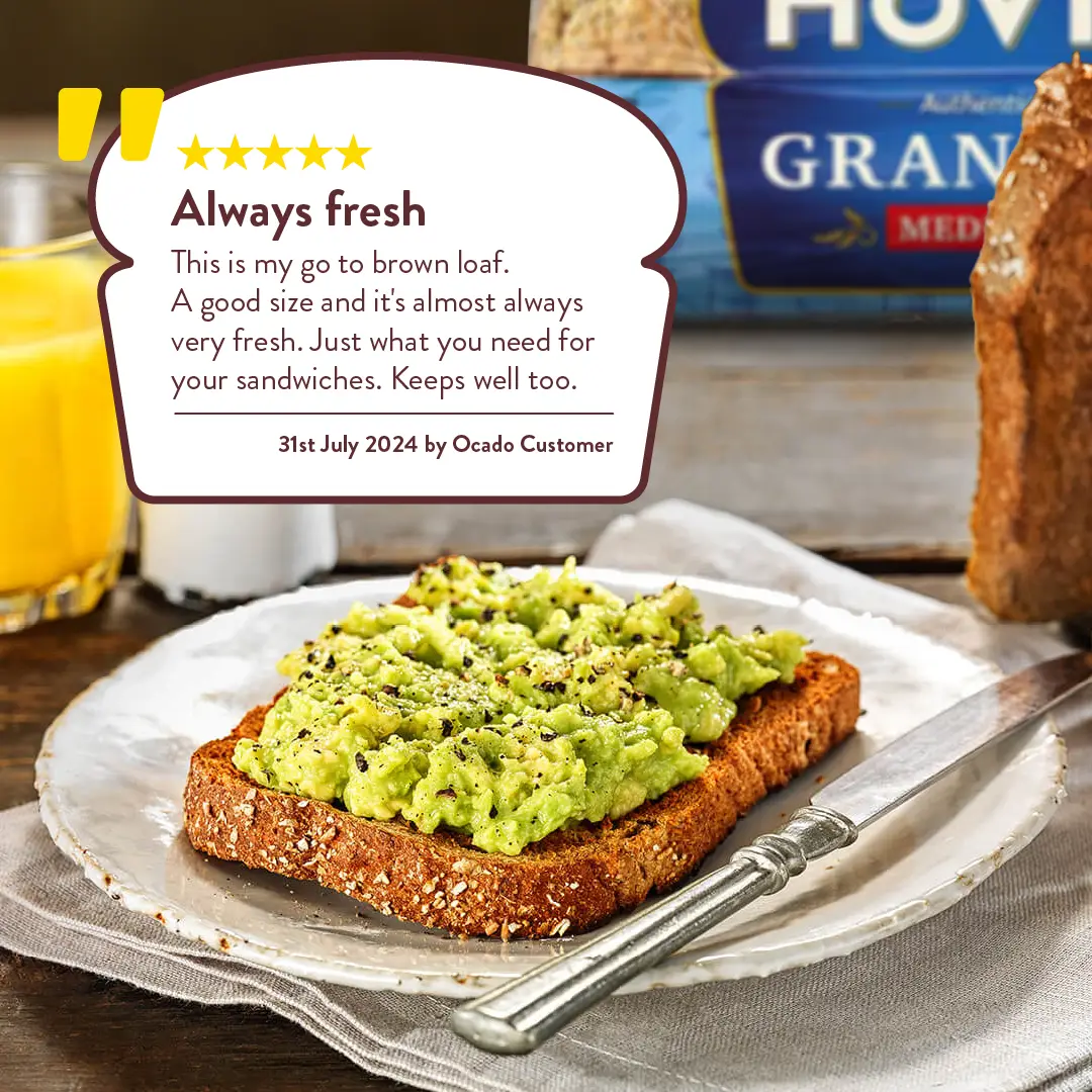 An avocado toast on a plate. On the background, a loaf of Hovis Granary medium sliced. A white loaf shape with a five star review.