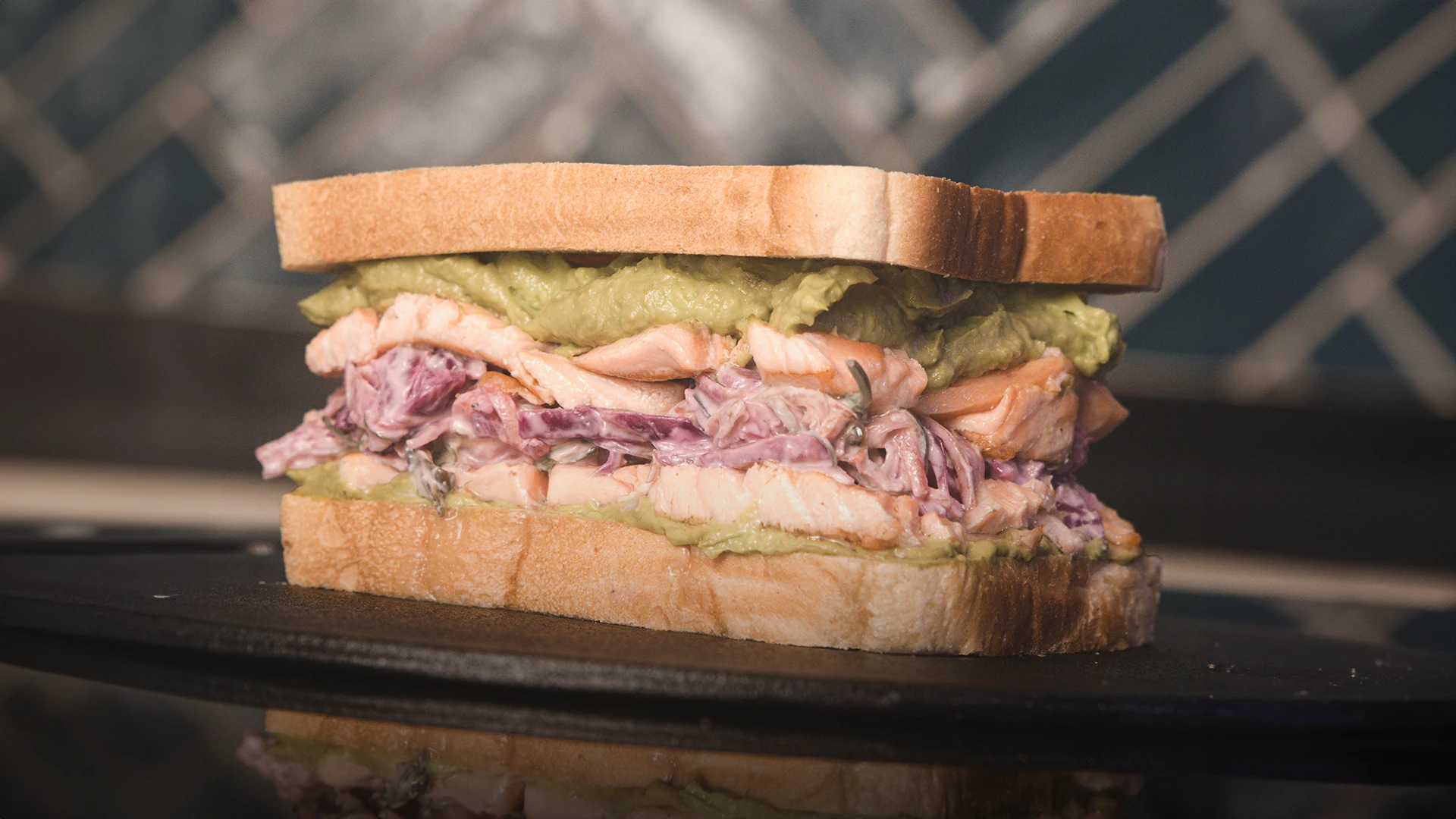 The finished sandwich with salmon, avocado and red cabbage coleslaw. 