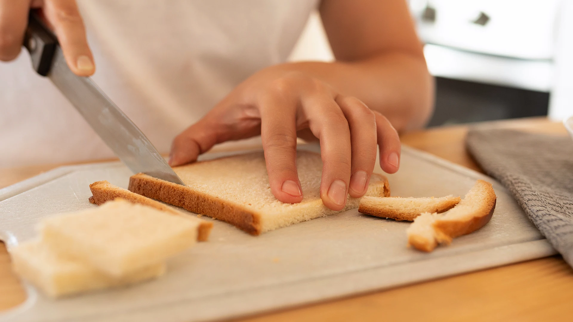 Crusts being cut off a Hovis® Soft White slice.