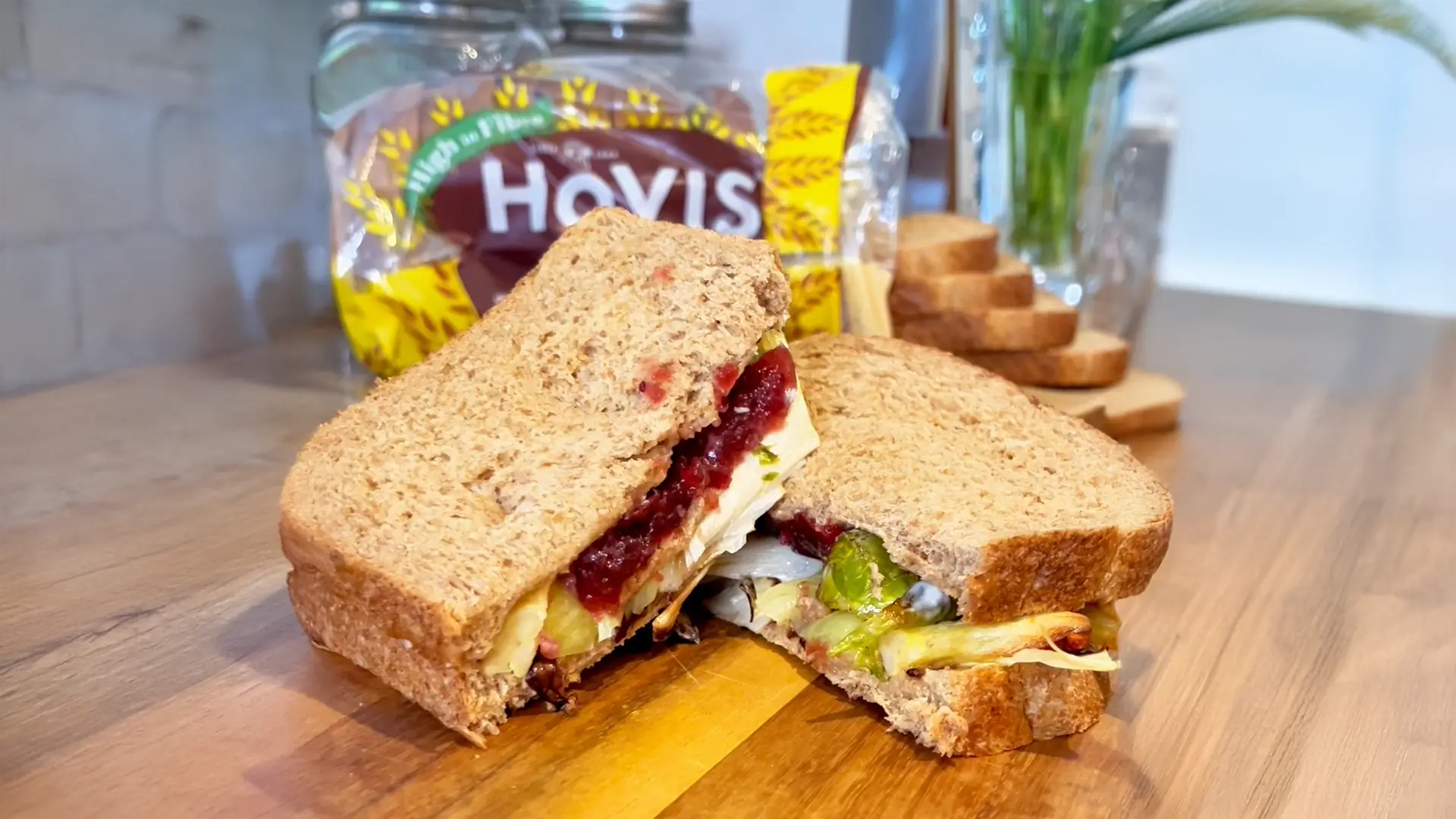 Two Hovis Tasty Wholemeal Medium Sliced sandwiches filled with turkey, cranberry, pigs in blankets, carrots and Brussel sprouts.