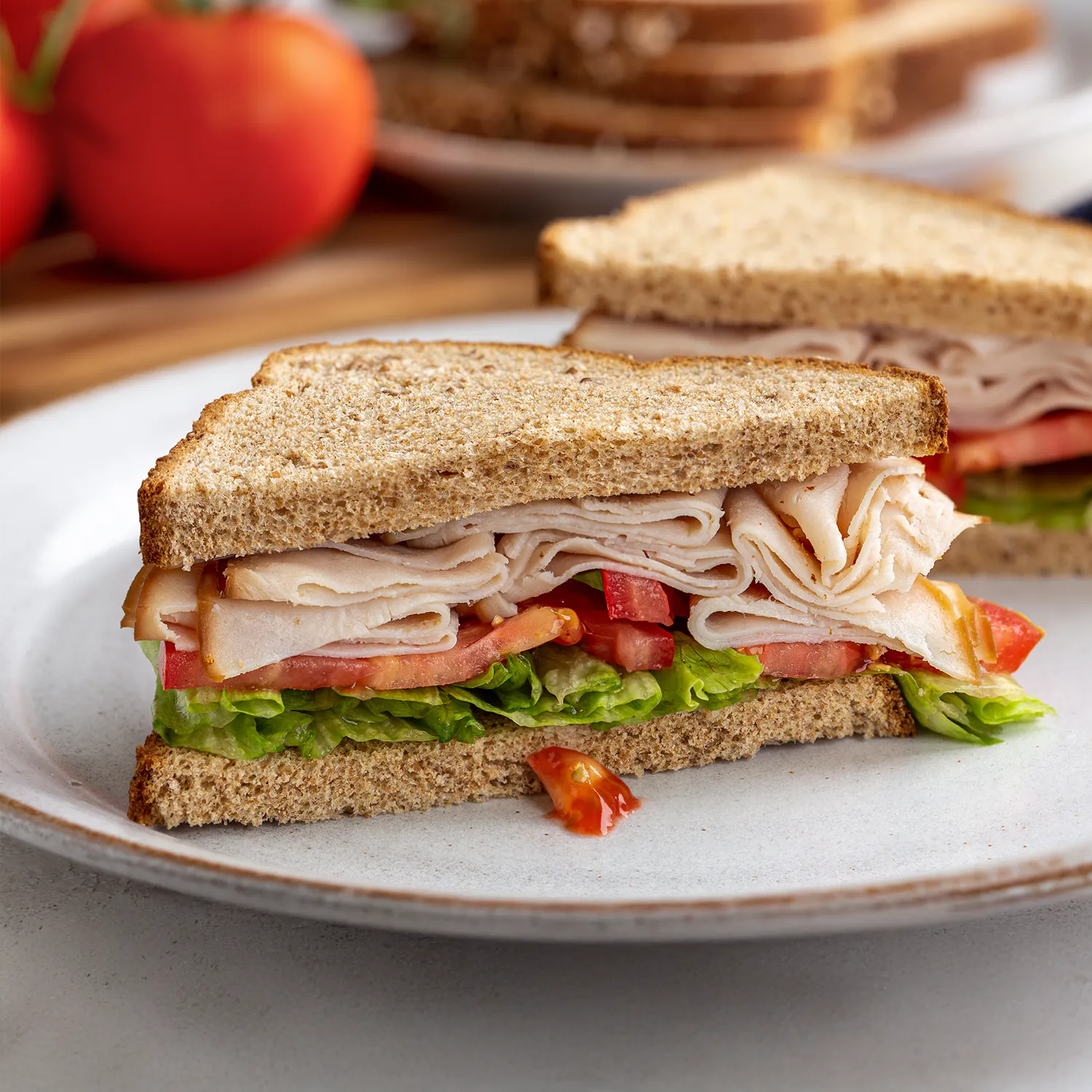 A Nimble® Wholemeal sandwich filled with thin slices of leftover turkey, lettuce, tomato and mayonnaise.